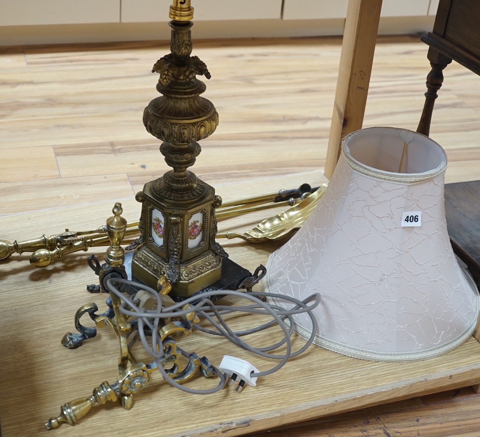 A brass table lamp and various fire implements